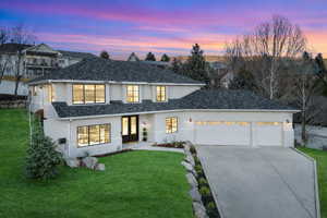 Modern farmhouse with a front yard, a garage, stucco siding, driveway, and french doors
