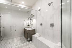 Bathroom with vanity, a stall shower, and recessed lighting