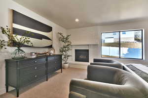 Living area with recessed lighting, a fireplace, and carpet floors