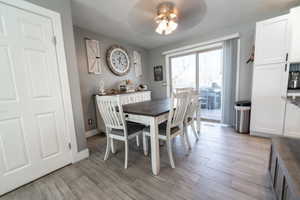 Dining area featuring wood tiled floors and a ceiling fan