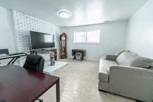 Living room featuring a textured ceiling and baseboards