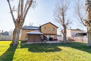 Rear view of property with a patio and a fenced backyard
