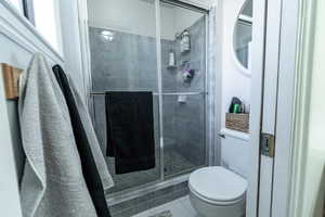 Full bath with a stall shower and tile patterned flooring