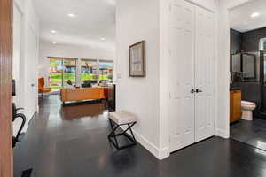 Hall with recessed lighting, dark wood finished floors, and plenty of natural light