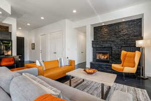 Living room featuring a fireplace, recessed lighting, and wood finished floors