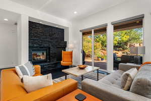Living area featuring a fireplace, wood finished floors, and recessed lighting
