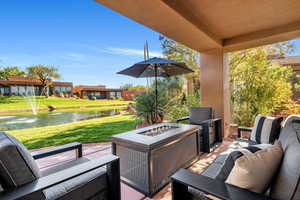 View of patio with a water view and an outdoor living space