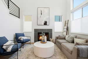 Sitting room with a tile fireplace and wood finished floors