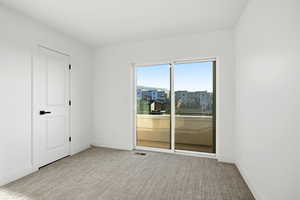 Empty room featuring light carpet and baseboards