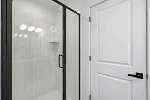 Full bathroom featuring a shower stall