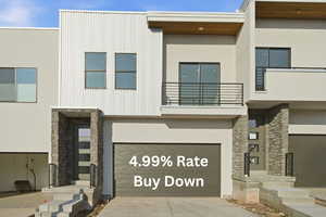 Contemporary house with stone siding, a garage, concrete driveway, and stucco siding