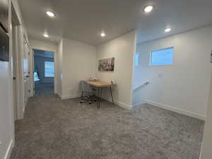 Loft area for various uses including home office with baseboards and recessed lighting