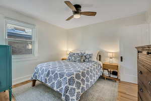 Bedroom with light wood-style floors and ceiling fan
