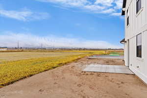 View of yard featuring a rural view and a patio