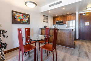 Dining area with recessed lighting and light wood finished floors