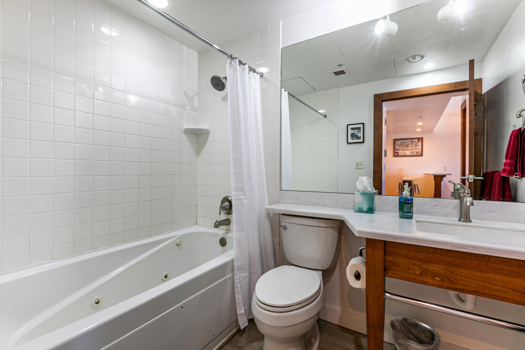 Bathroom featuring shower / tub combo, vanity, and recessed lighting