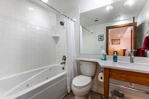 Bathroom featuring shower / tub combo, vanity, and recessed lighting