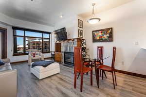 Dining space featuring a tile fireplace and wood finished floors