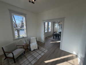 Sitting room featuring a chandelier and dark wood-type flooring