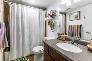 Full bath featuring vanity and shower / bathtub combination with curtain