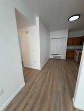 Unfurnished dining area with baseboards and light wood-style floors
