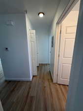 Corridor featuring wood finished floors and baseboards
