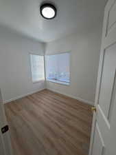Unfurnished room with light wood finished floors and baseboards
