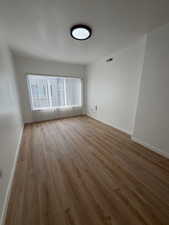Spare room with light wood-style flooring and baseboards