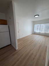 Unfurnished room featuring light wood-type flooring and baseboards