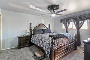 Large primary suite offers a triple closet, ceiling fan, crown molding, and remodeled bathroom with double vanity plus new shower and tub