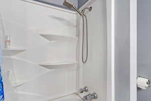 Large primary suite offers a triple closet, ceiling fan, crown molding, and remodeled bathroom with double vanity plus new shower/tub