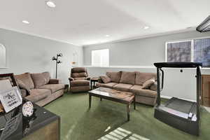 Living area with carpet, ornamental molding, and recessed lighting
