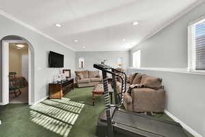 Workout room with arched walkways, ornamental molding, carpet flooring, and recessed lighting