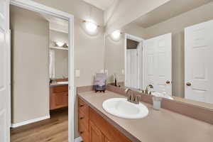 Bathroom featuring vanity and light wood-style floors
