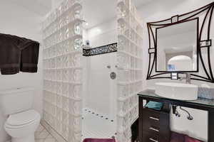 Full bath with a walk in shower, tile patterned flooring, and vanity