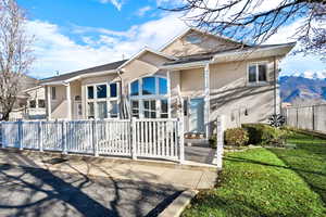 View of front of home featuring a fenced front yard and stucco siding