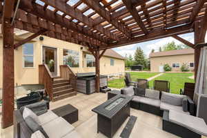View of patio with an outdoor living space with a fire pit and a pergola
