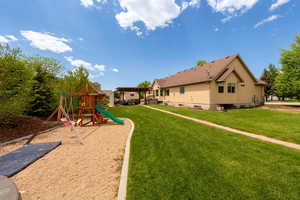 Community playground with a lawn and a pergola