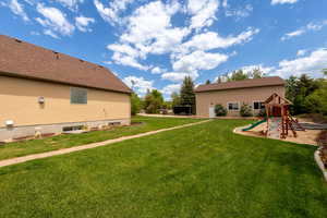 View of grassy yard with a playground