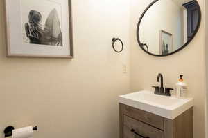 Bathroom featuring vanity and a textured wall