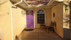 Property entrance featuring stucco siding