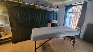 Carpeted bedroom featuring baseboards