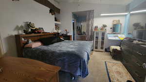 Bedroom with carpet and vaulted ceiling