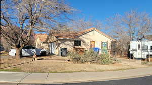 View of front of house featuring stucco siding and a tile roof