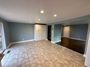 Unfurnished bedroom with recessed lighting and light tile patterned flooring