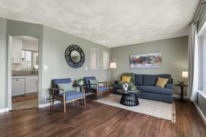 Living room with dark wood-type flooring