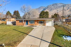 Ranch-style home with brick siding, driveway, and a mountain view
