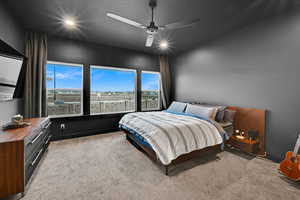 Primary Bedroom featuring light colored carpet and ceiling fan