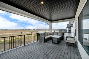 Wooden terrace featuring outdoor lounge area