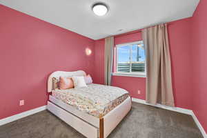 Bedroom with carpet flooring and a textured ceiling